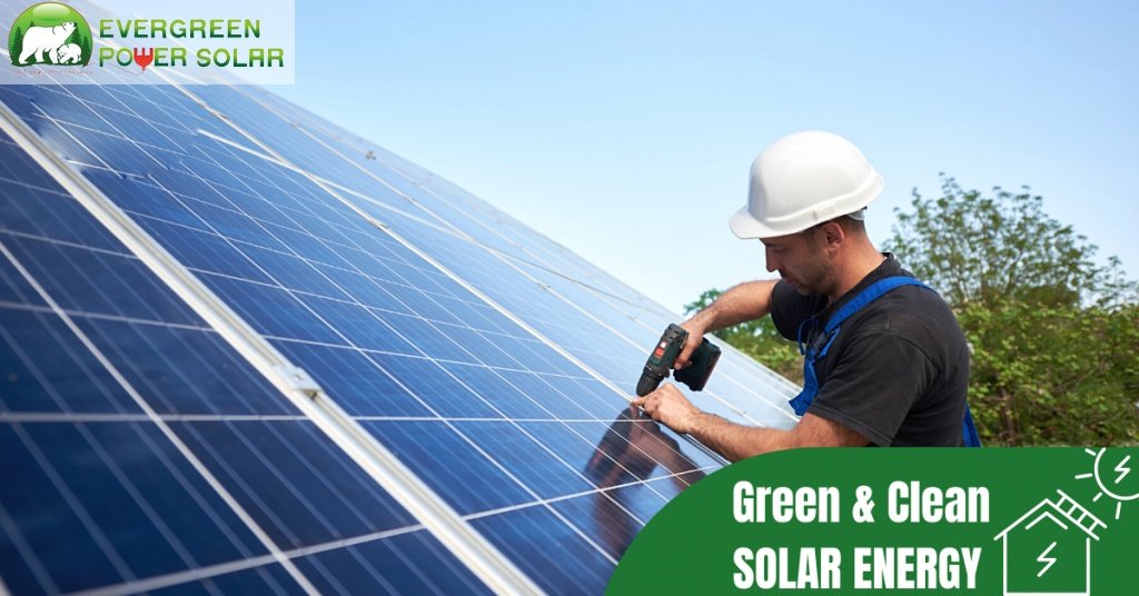 A man in a hard hat using a drill to install solar panels