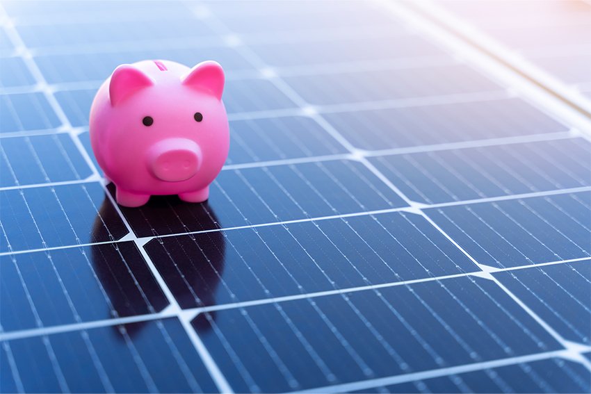 A pink piggy bank on a solar panel